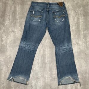Guess Blue Bootcut Jeans with Distressed Hem and Back Pocket Detail